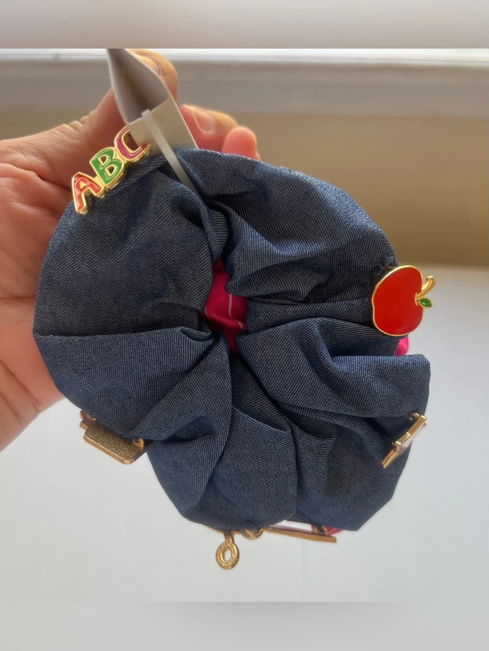 This is a 3-pack of themed hair scrunchies designed with school-related motifs.